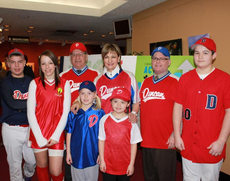 Minister of State Lynne Yelich is joined by a large group of members from the Duncan Junior Baseball team, as well as Mayor Tom Walker and Mayor Phil Kent.