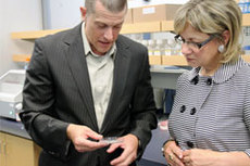 Dr. Marco Marra, Director of the Genome Sciences Centre and Minister Lynne Yelich examine the lab equipment during a tour of the centre.